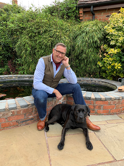 Graeme Hall with black Labrador dog 