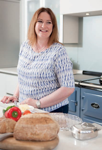 Caroline cooking in front of her Dartmouth Blue AGA 
