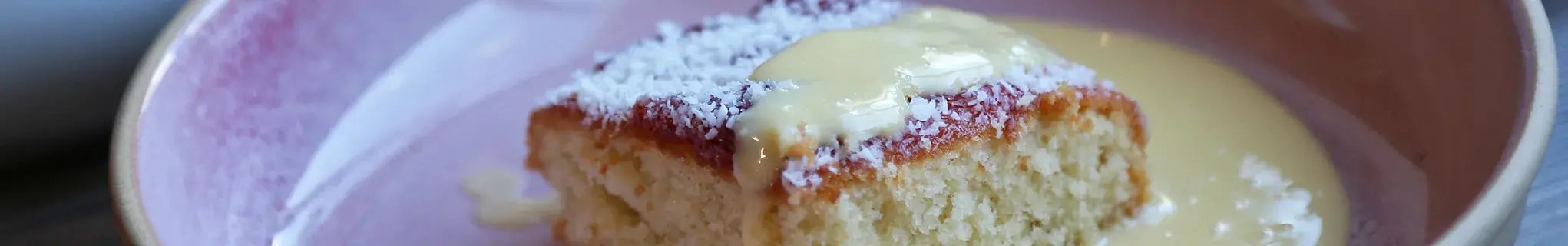 AGA Coconut Jam Sponge Pudding covered in custard