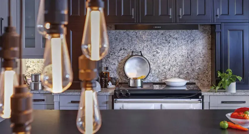 Black and white kitchen featuring AGA cooker and statement lighting