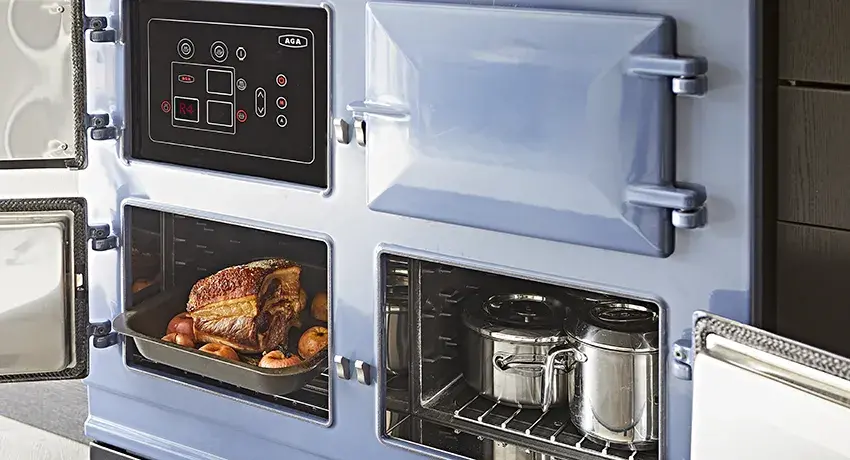 AGA Cooker Collections in Dartmouth Blue with open oven doors