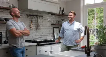 Ross and Ian standing in front of their AGA eR7 cooker in White
