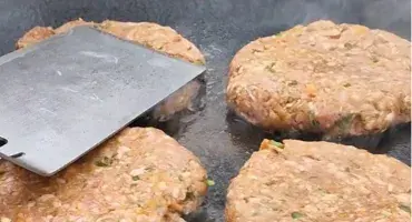 Lamb patties cooking on the AGA Outdoor Grill