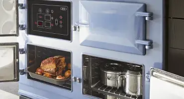 AGA Cooker Collections in Dartmouth Blue with open oven doors
