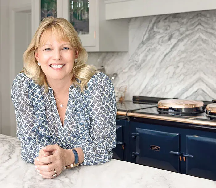 Karen Howes in her kitchen with blue AGA