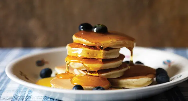 Drop Scones on a plate with blueberries and maple syrup